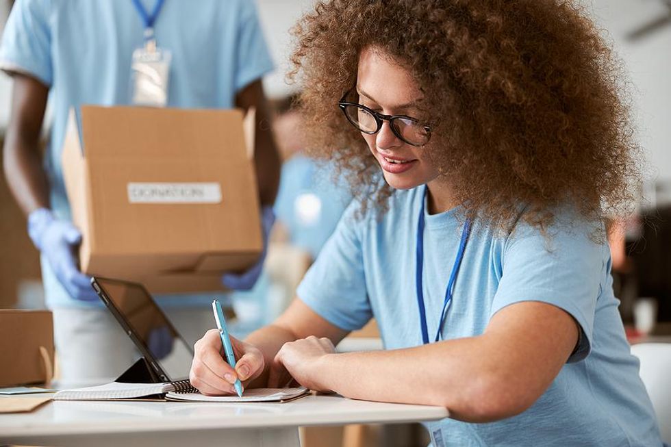 Woman takes notes while volunteering
