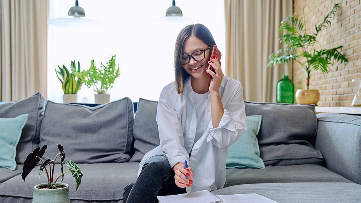 Woman talking on phone is prepared for her phone interview