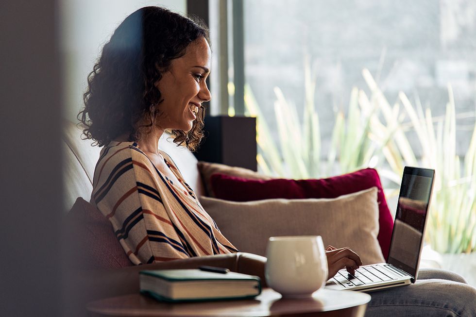 Woman talks to a career coach on her laptop