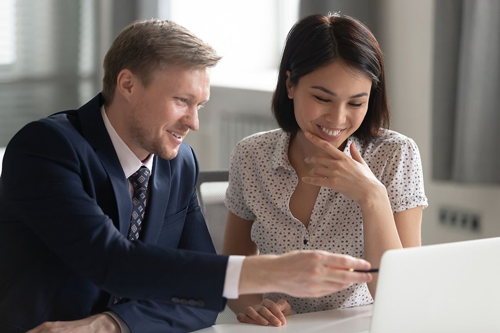 Woman talks to a coworker after successfully relaunching her career