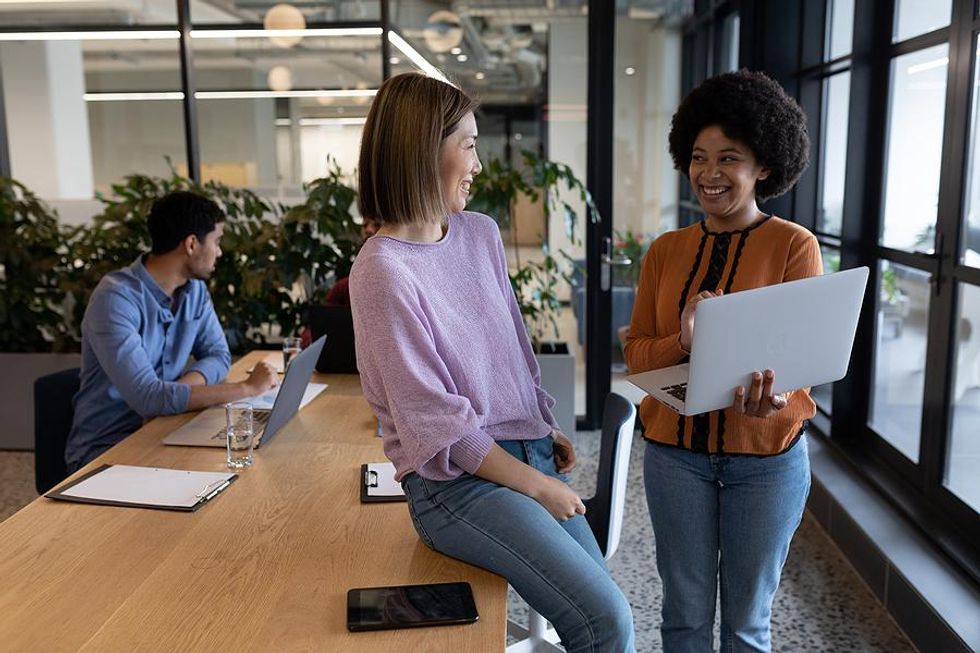 Woman talks to a coworker and practices influencing without authority