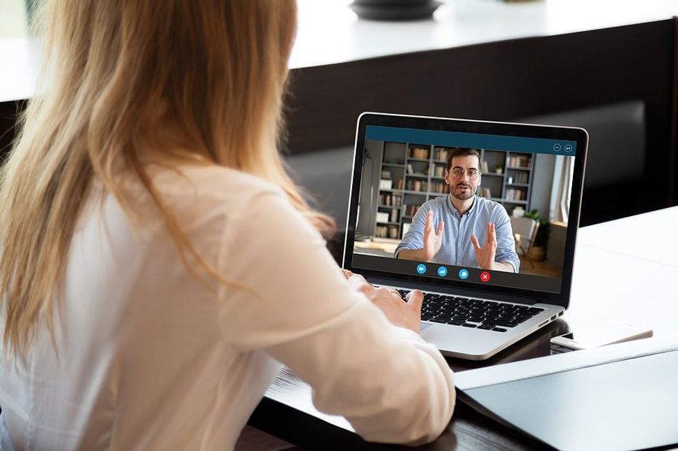 Woman talks to a difficult customer/client on a video call