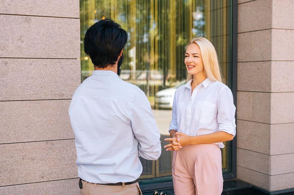 Woman talks to a work colleague