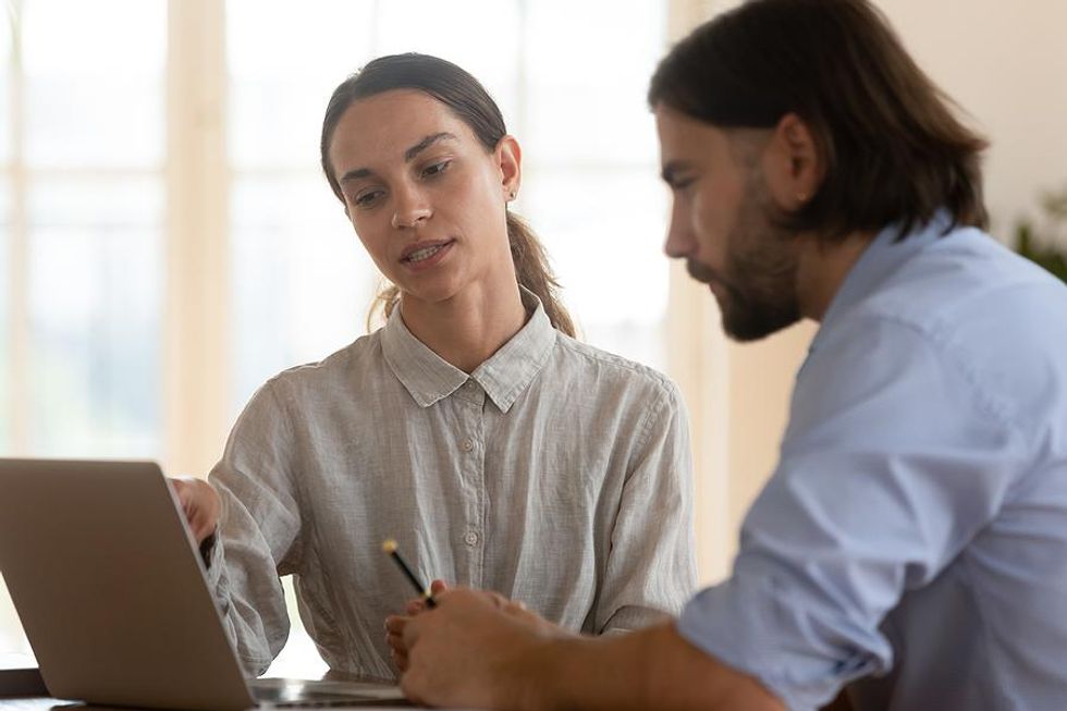 Woman talks to her bad boss at work