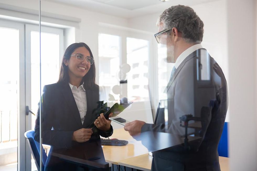 Woman talks to her boss about getting promoted
