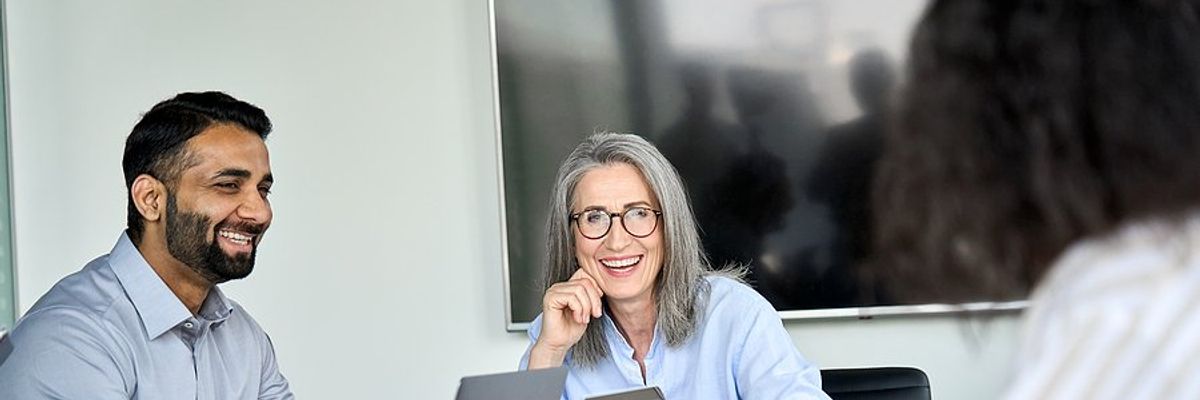 Woman talks to her boss during a work meeting