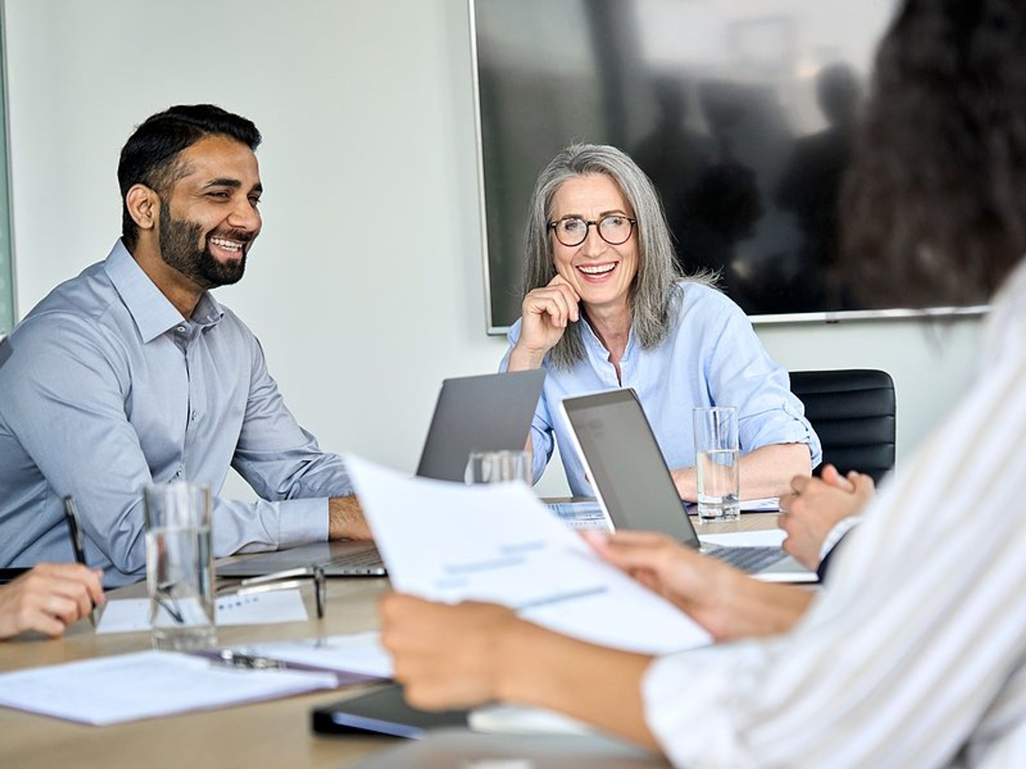 Woman talks to her boss during a work meeting