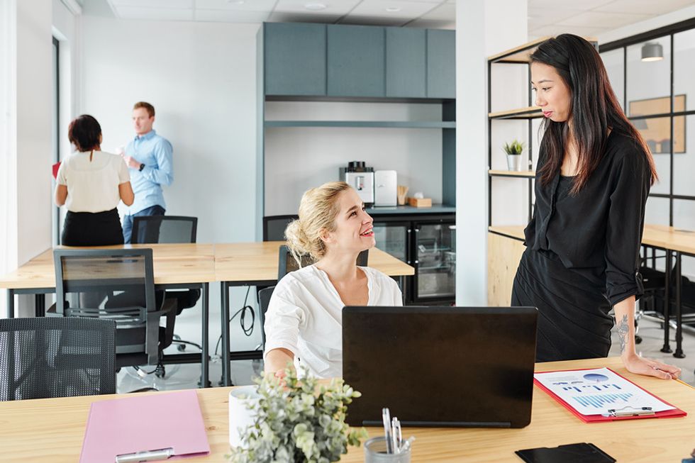 Woman talks to her colleague at work