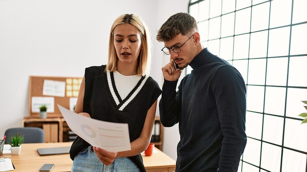 Woman talks to her coworker in the office