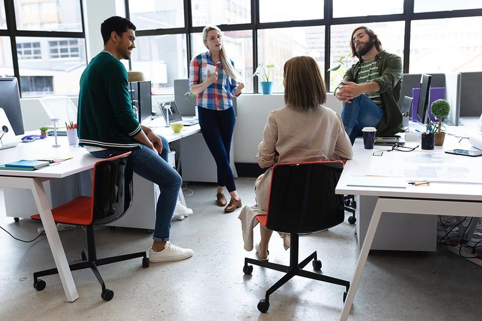 Woman talks to her coworkers