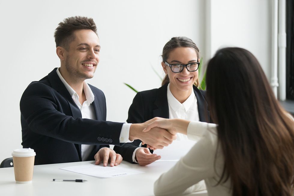 Woman thanks the hiring manager after a group interview