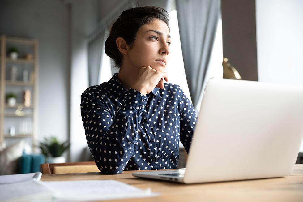 Woman thinking about lying on her resume