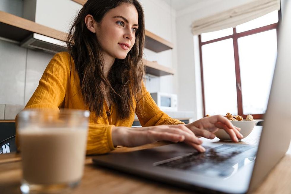 Woman types on her laptop