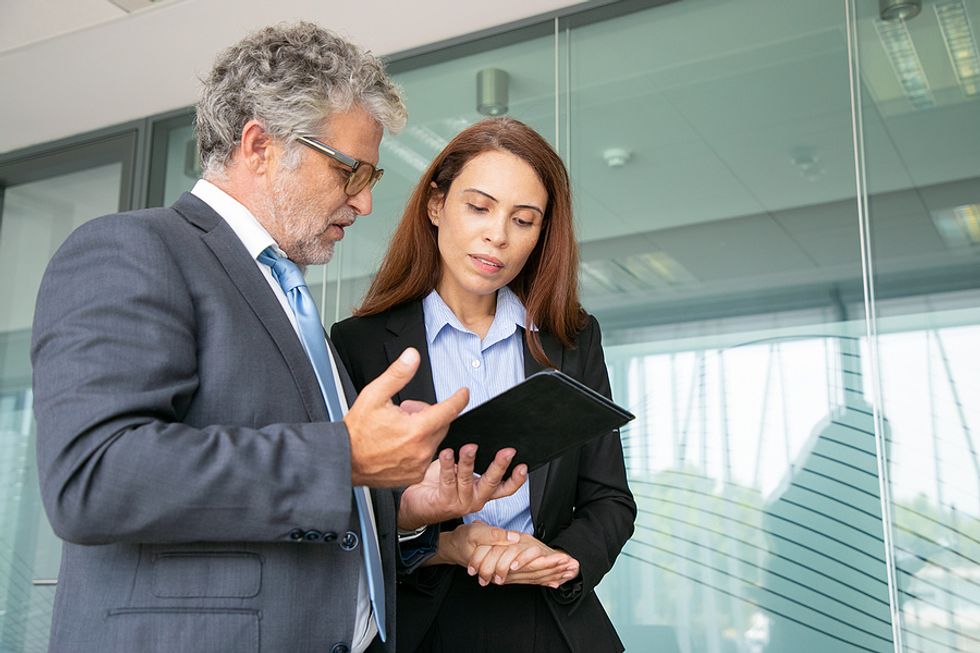 Woman uses her listening skills while talking to her boss