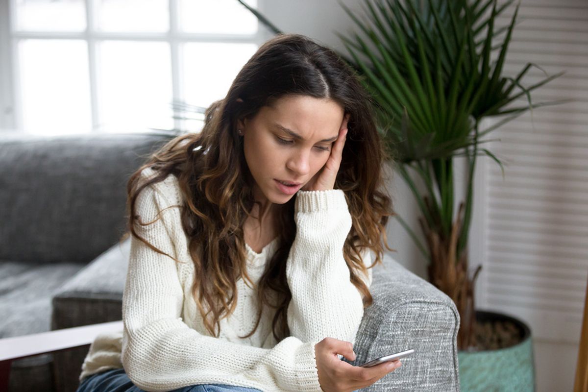 Woman waiting for a job offer looks at her phone