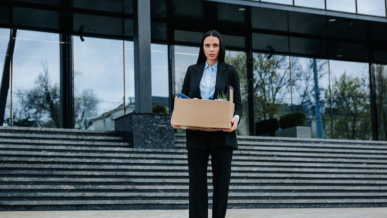 Woman who recently got fired/laid off holds a box of her things