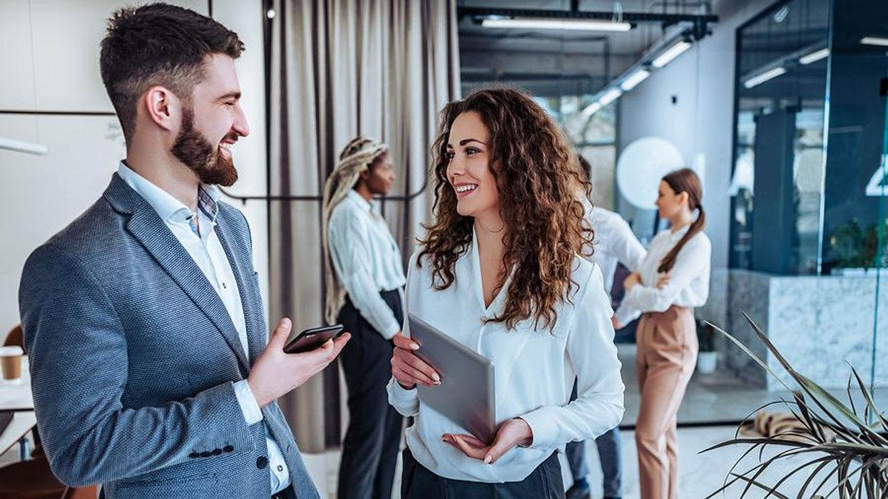 Woman who understands her workplace communication/interaction style talks with a coworker