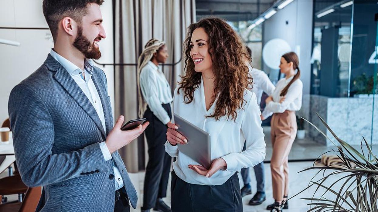 Woman who understands her workplace communication/interaction style talks with a coworker