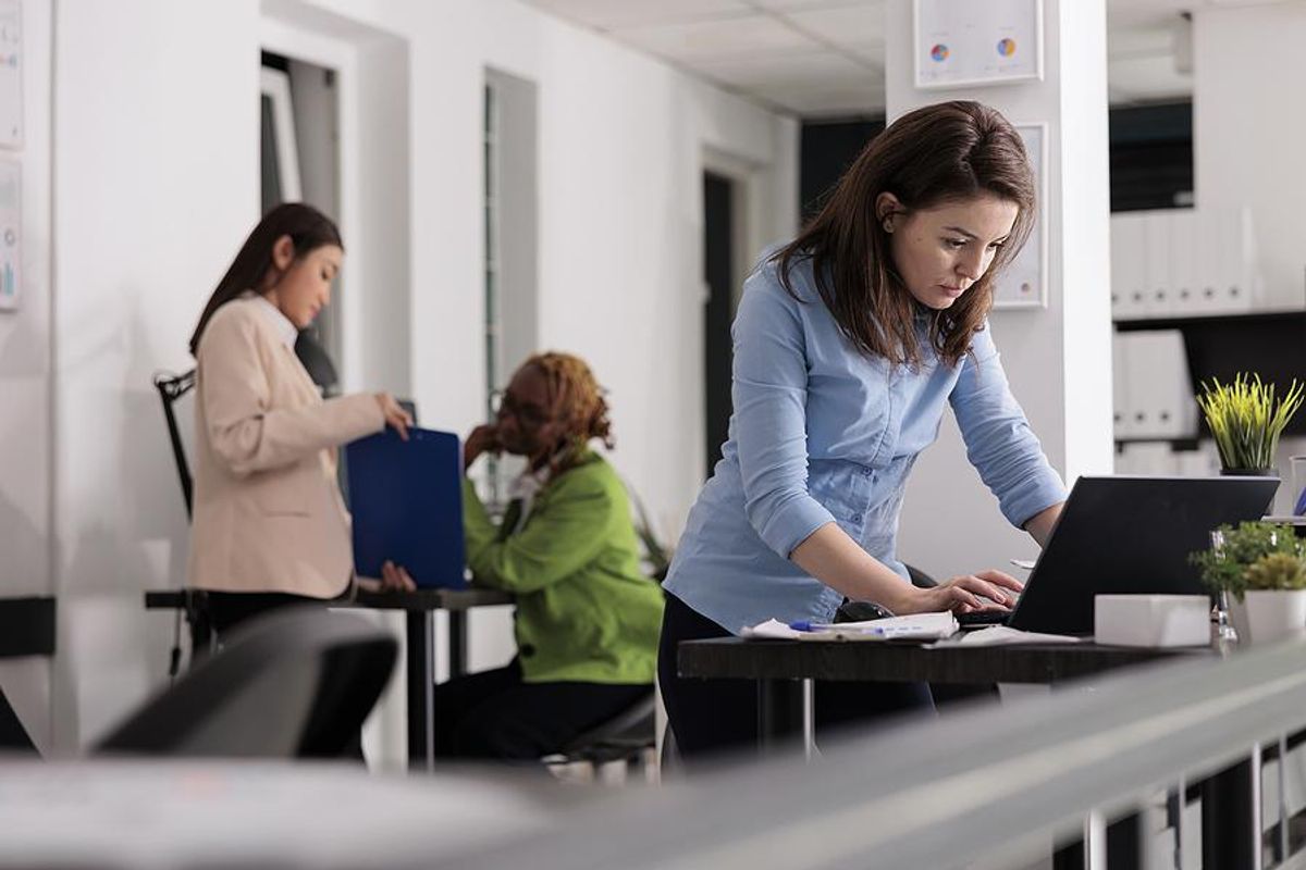 Woman with no friends at work types on her laptop