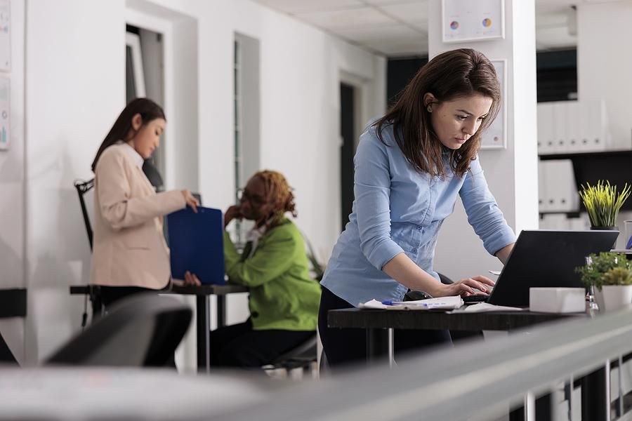 Woman with no friends at work types on her laptop