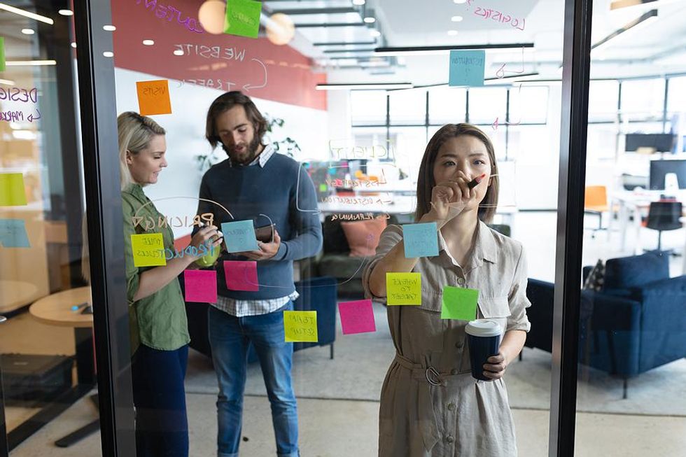 Woman works with two people in her network