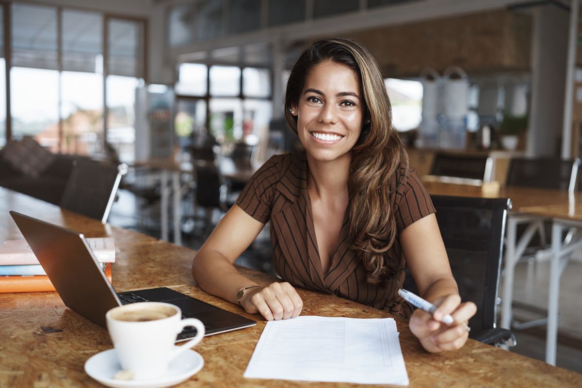 Woman writes a 30-60-90 day plan for a job interview