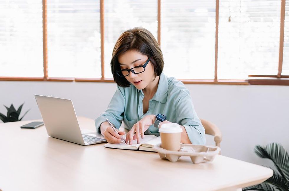 Woman writes down her career goals for the new year