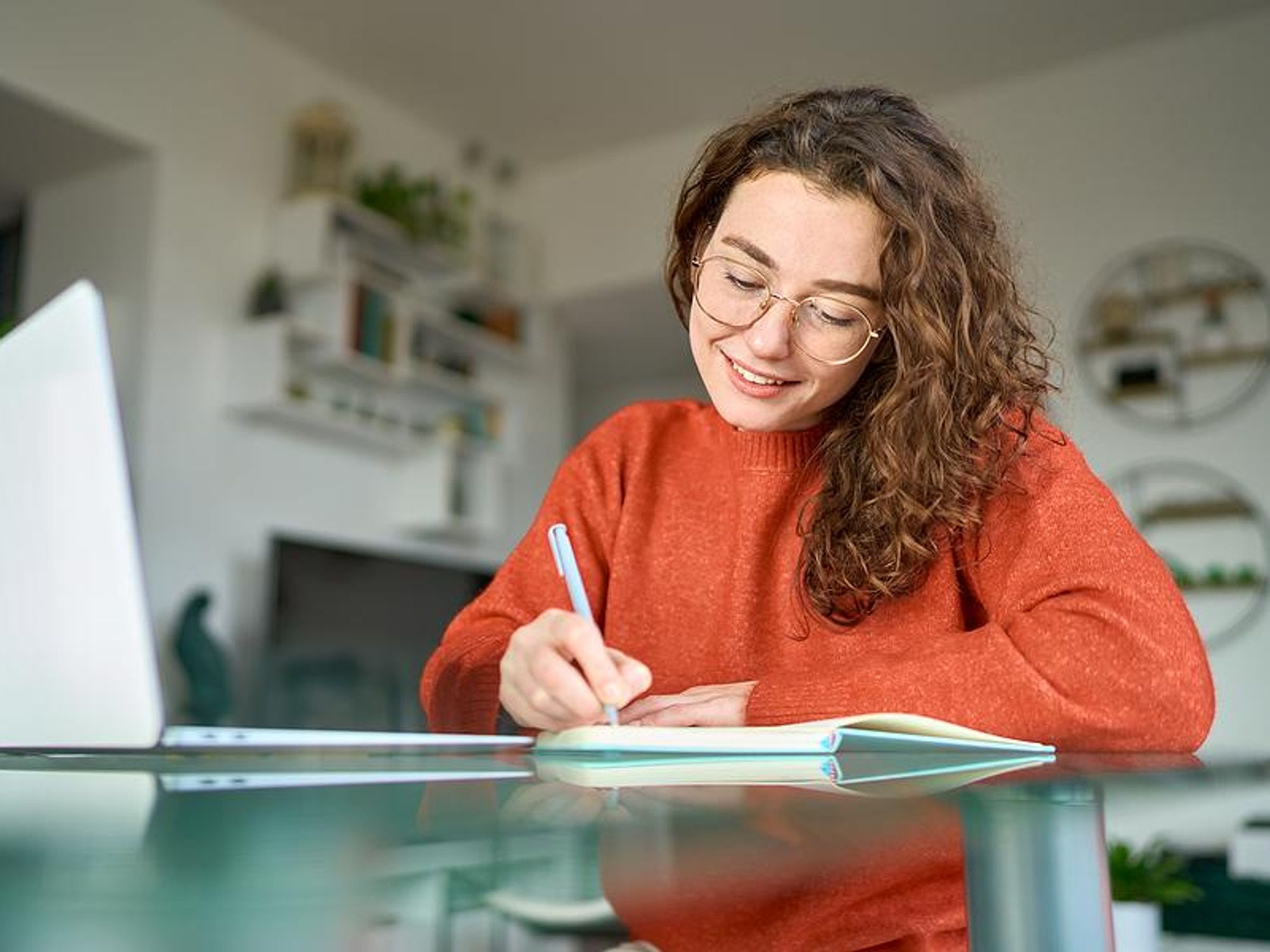 Woman writes down her New Year's resolutions for her career