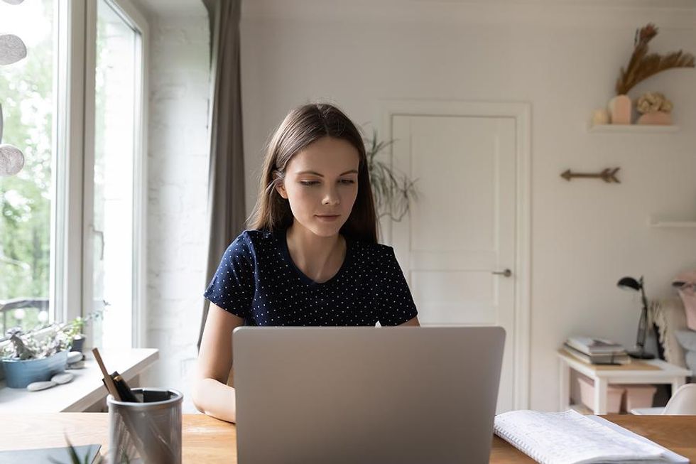 Woman writes her cover letter on her laptop