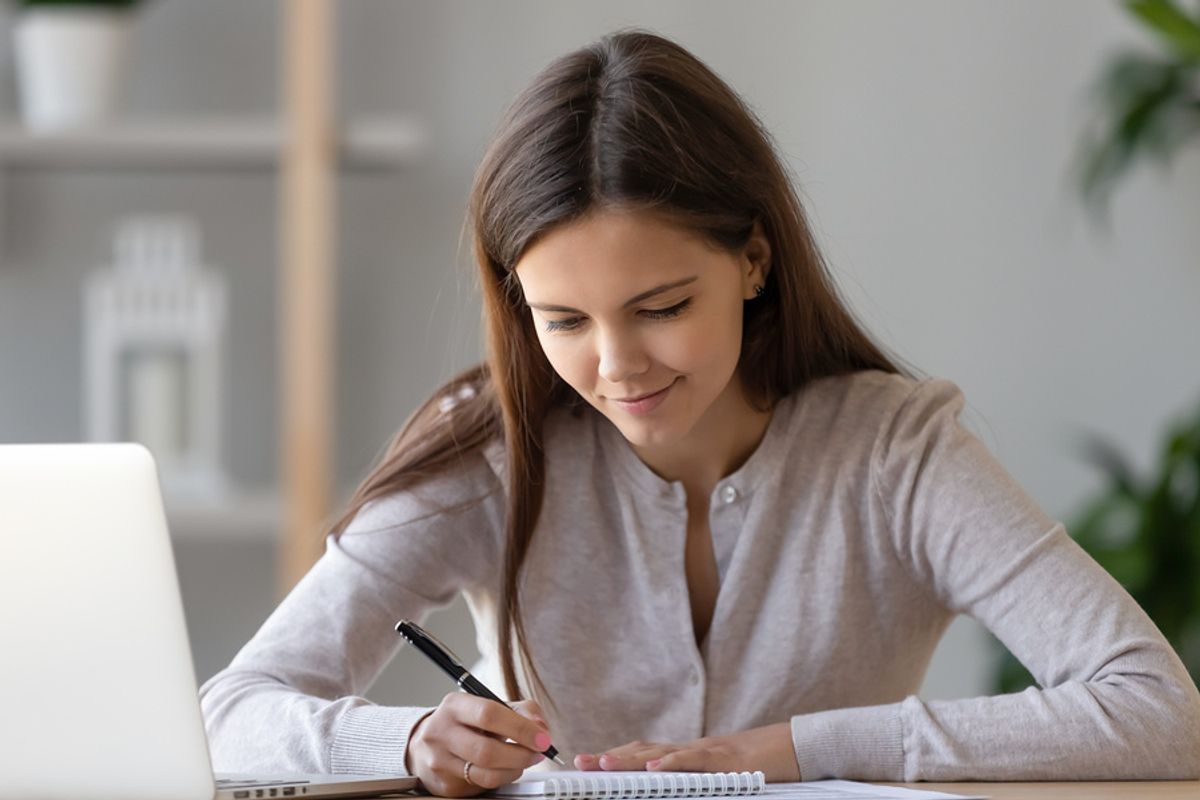 Woman writing down her personal branding statement