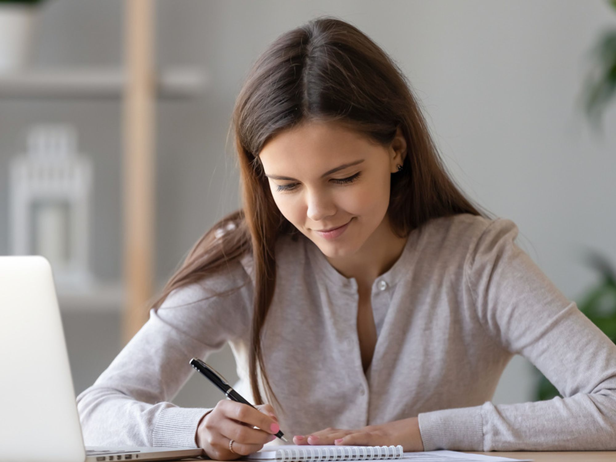 Woman writing down her personal branding statement