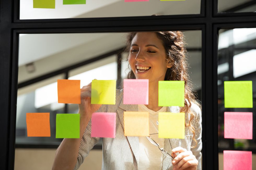 Woman writing notes to herself to read on Monday