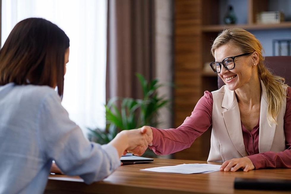 Women shake hands after a mock interview