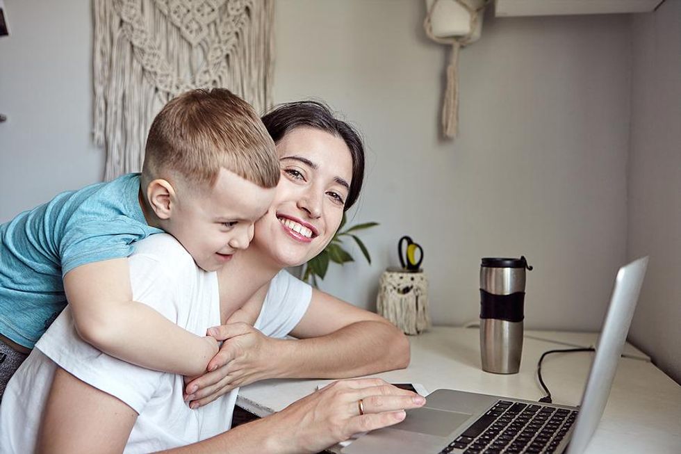 Working mom smiles at the camera