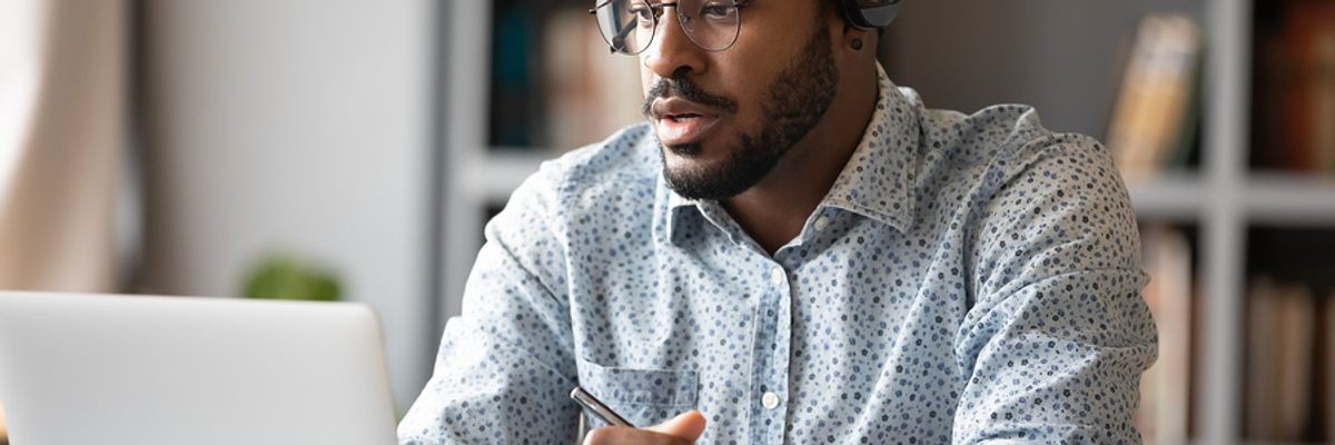 Young businessman on laptop takes an online course on professional development