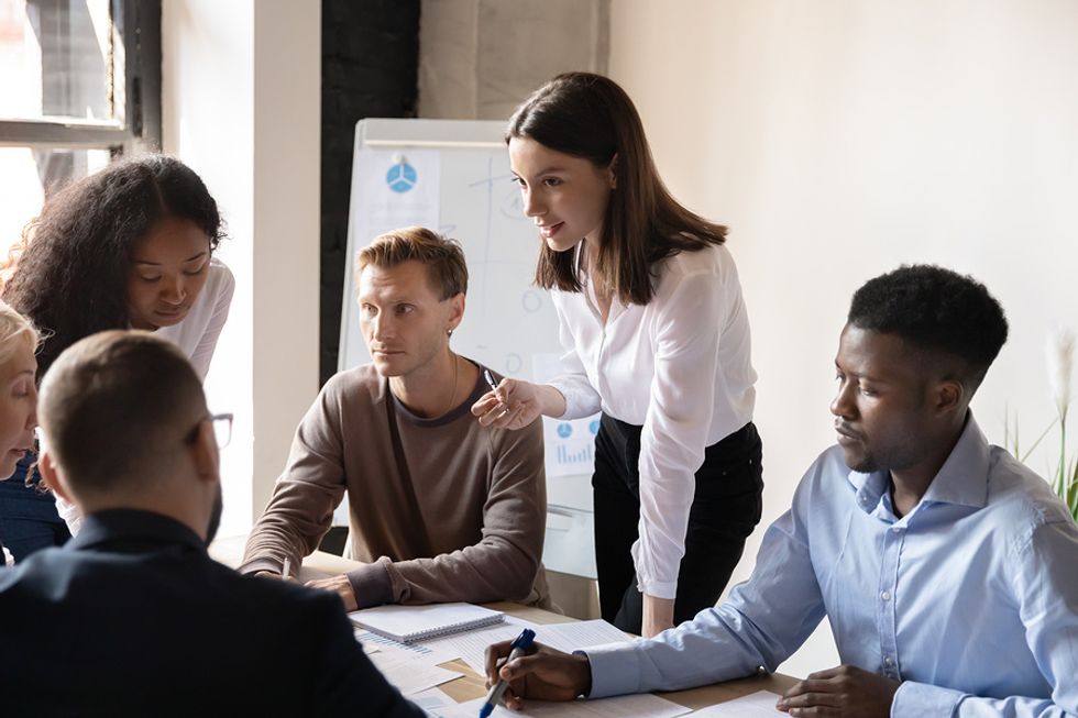 Young employees learning on the job during a work meeting