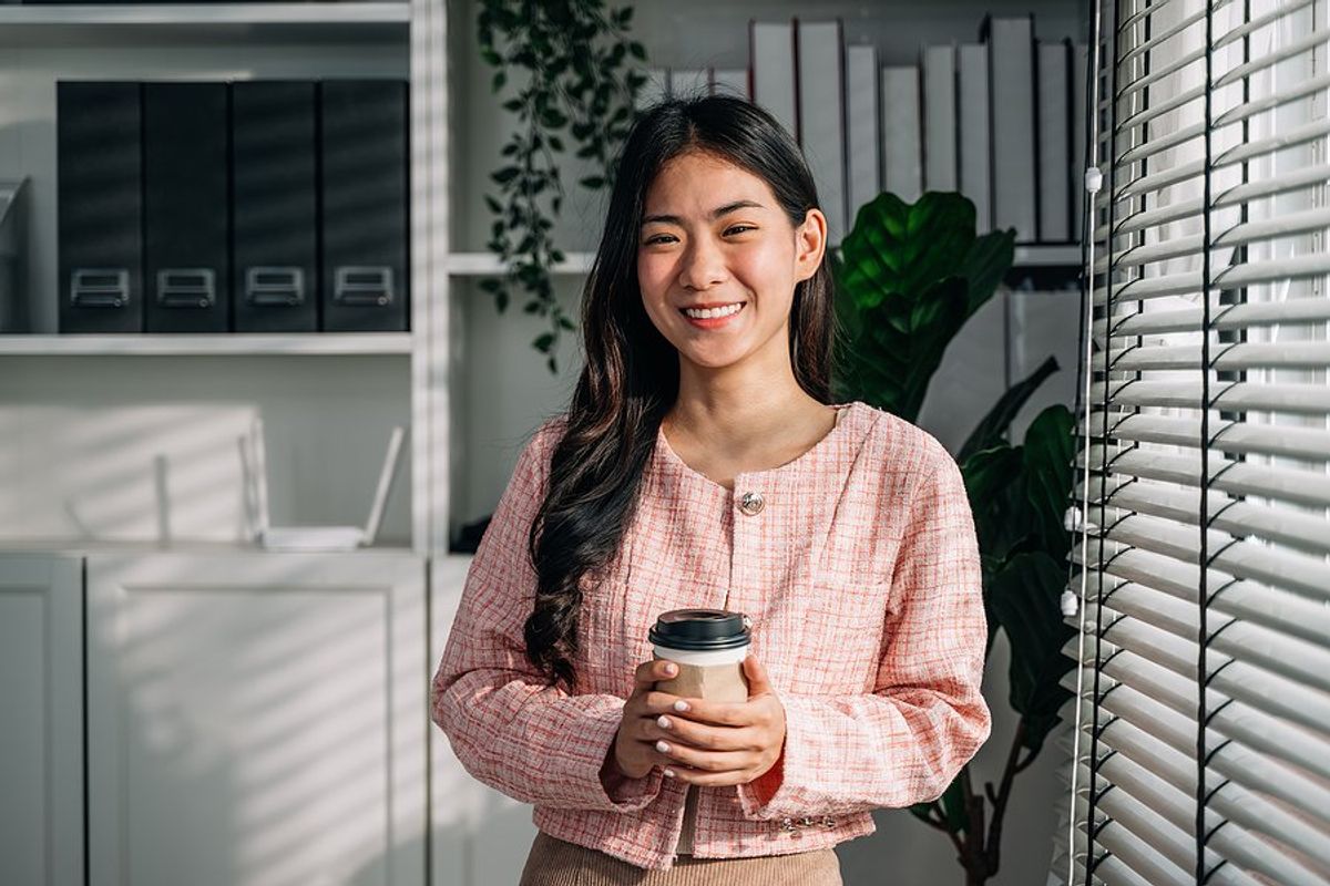 Young, happy, professional woman learns to influence without authority at work