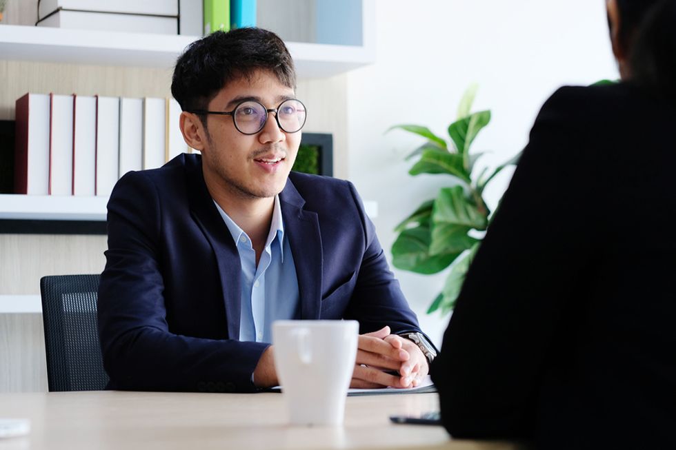 Young job candidate talking about what he can bring to the company during a job interview.