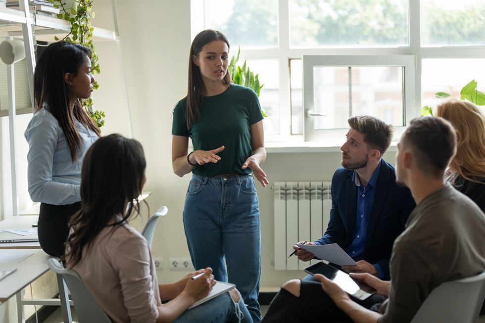 Young manager talks to a group of interns