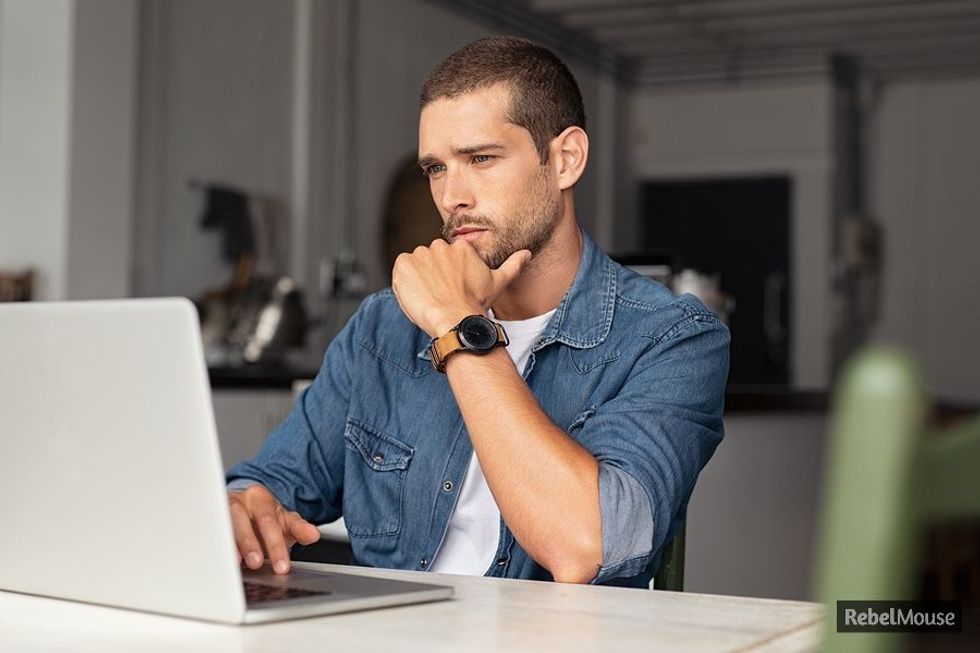 Young professional carefully looks over his LinkedIn profile