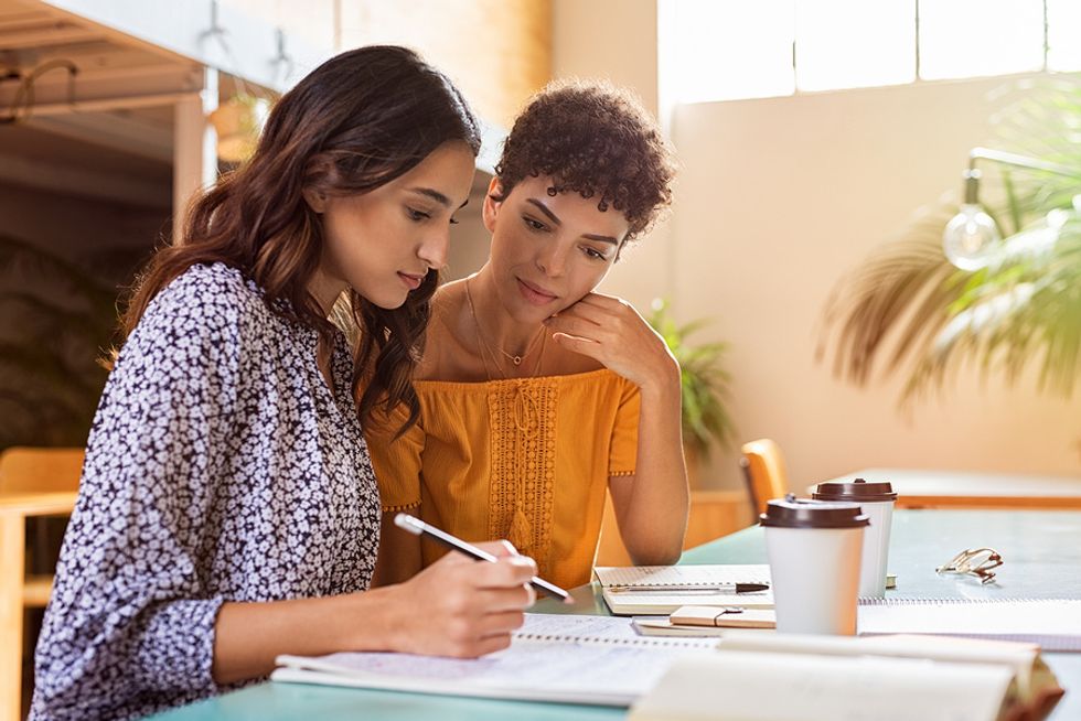 Young professional does a mock interview with her friend