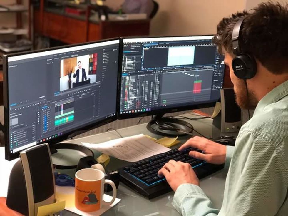Young professional edits video.