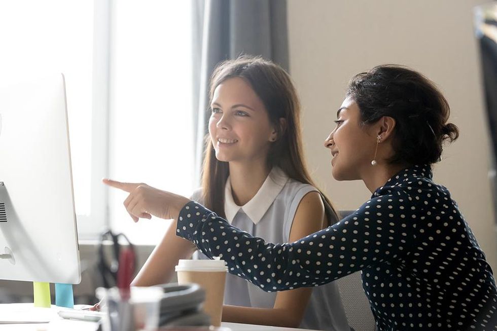 Young professional gets help from her mentor at work