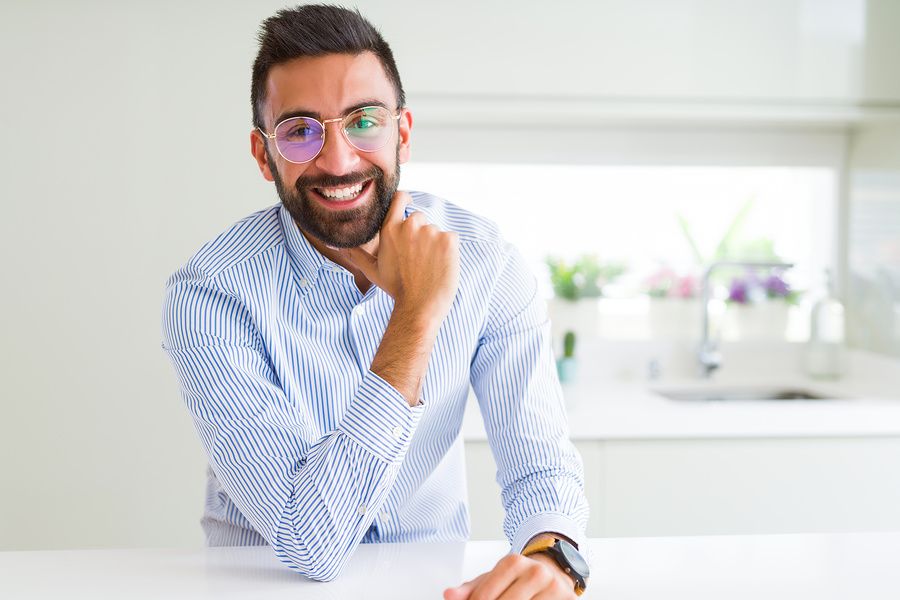 Young professional laughs while taking a break from work.