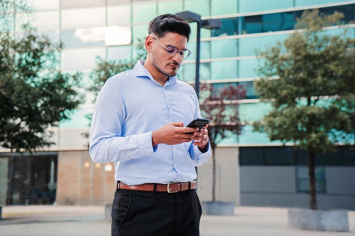Young professional man checks his phone and realizes he's being ghosted after an interview