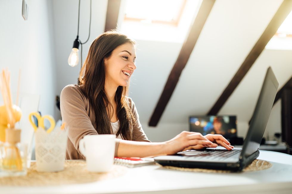 Young professional on laptop emails a colleague about a possible LinkedIn recommendation