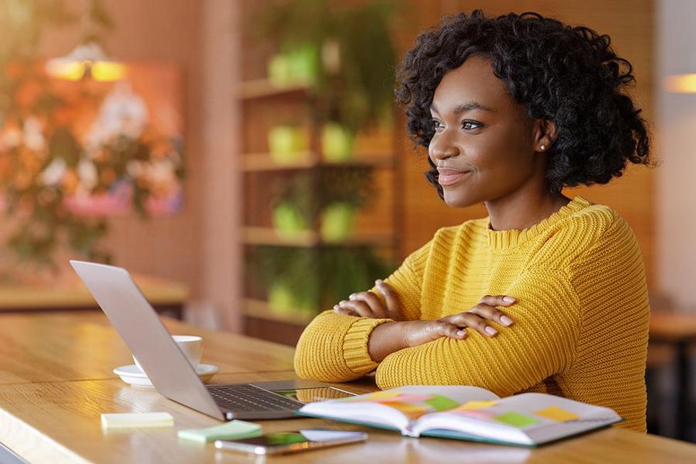 Young professional on laptop looks at job opportunities within her professional LinkedIn Group
