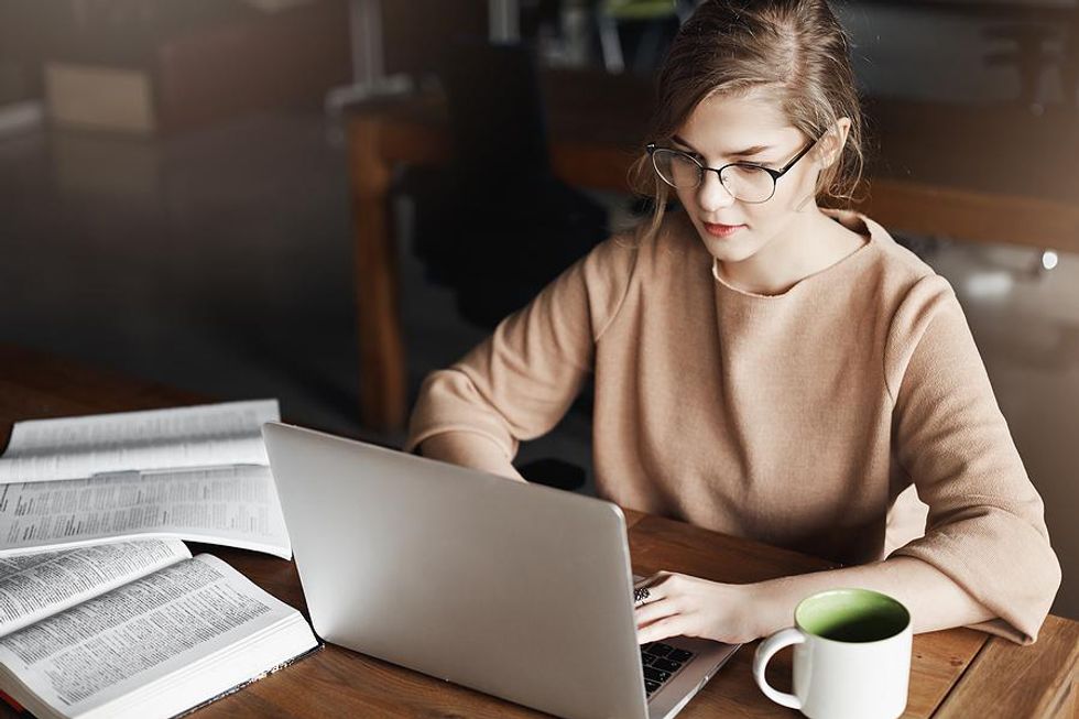 Young professional on laptop works actively on LinkedIn during her job search