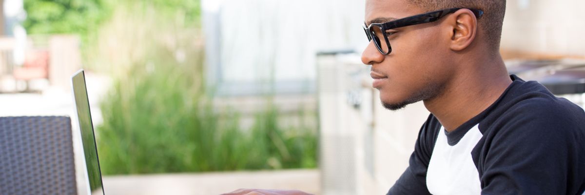 Young professional researches a company a few days prior to a job interview.