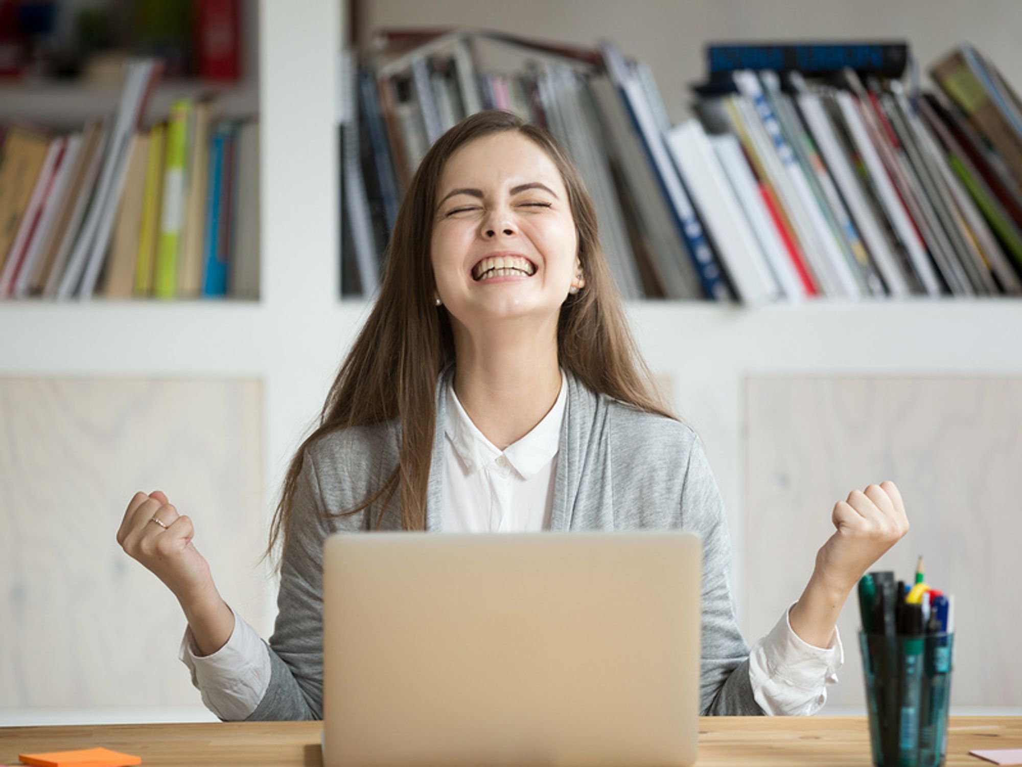 Young professional shows excitement over an accomplishment.